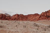 a woman is riding a horse in the desert